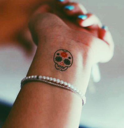 Sugar skull tattoo on the wrist