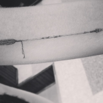Thin arrow tattoo