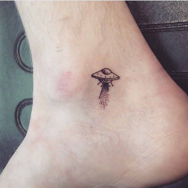 Tiny alien spaceship ankle tattoo