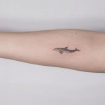 Tiny dolphin tattoo on the forearm