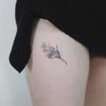 Tiny flower bundle tattoo on the thigh