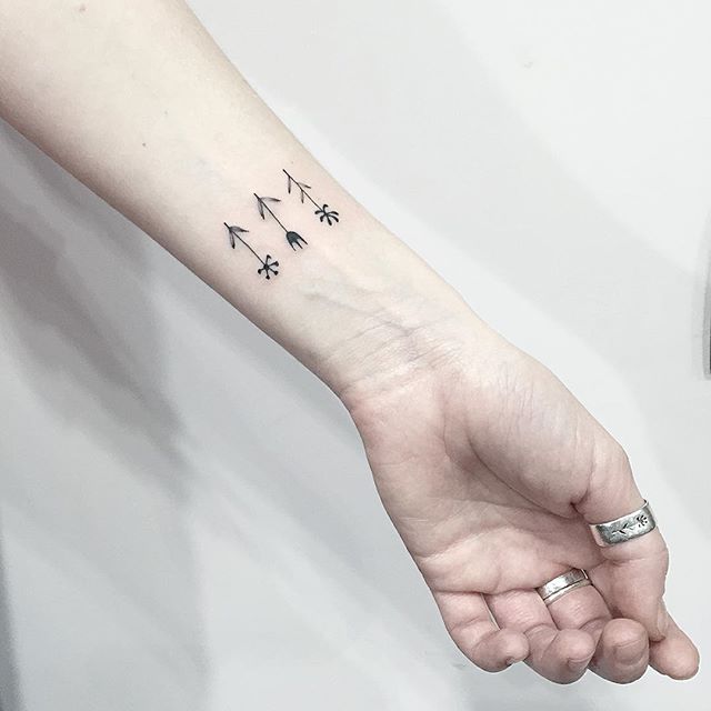 Tiny flower tattoos on the wrist 