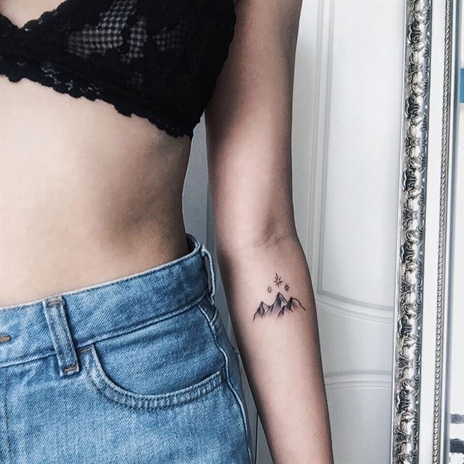 Tiny mountains forearm tattoo