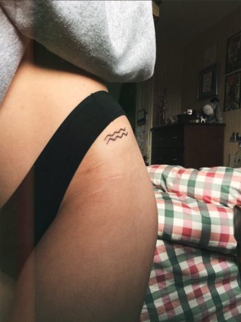 Tiny wave symbol tattoo