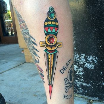 Traditional colorful dagger tattoo on the calf