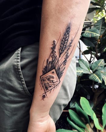 Wave in a rhombus and wild plants tattoo