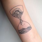 Waves in an hourglass tattoo