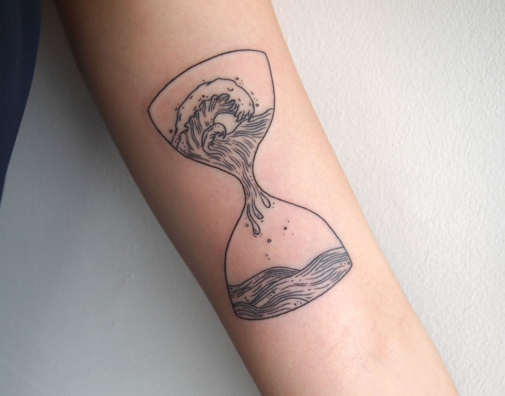 Waves in an hourglass tattoo
