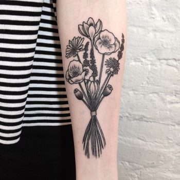 Wildflower bundle tattoo on the forearm