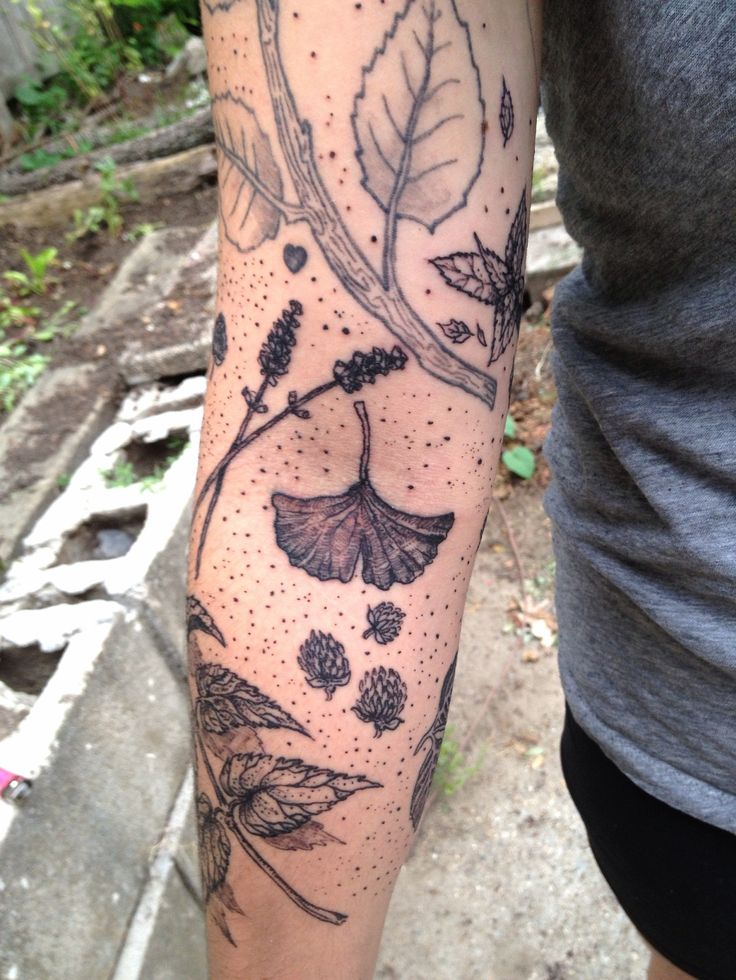 Wildflowers and leaves tattoo on the arm