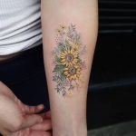 Yellow wildflowers tattoo on the forearm