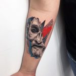 Abstract face tattoo on the forearm