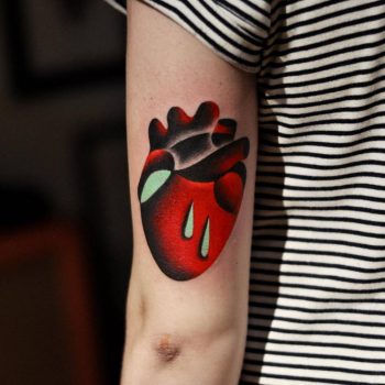 Abstract heart tattoo on the back of the arm