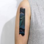 Abstract tattoo on the right upper arm