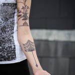 Beautiful geometric and flower tattoos on the arm