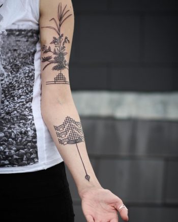 Beautiful geometric and flower tattoos on the arm