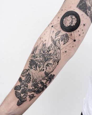 Beautiful tattoo of a hand and leaves