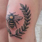 Bee and wreath tattoo on the knee