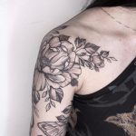 Black and gray flower tattoo on the shoulder