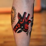 Black and red giraffe tattoo