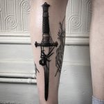 Black dagger and spider tattoo