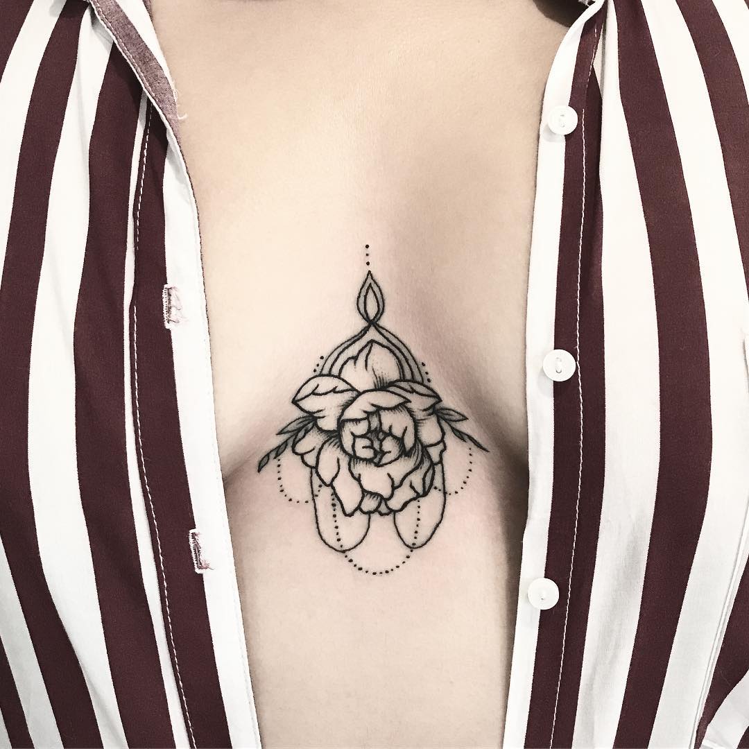 Black flower tattoo on the sternum