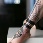 Black geometric pattern tattoo on the leg