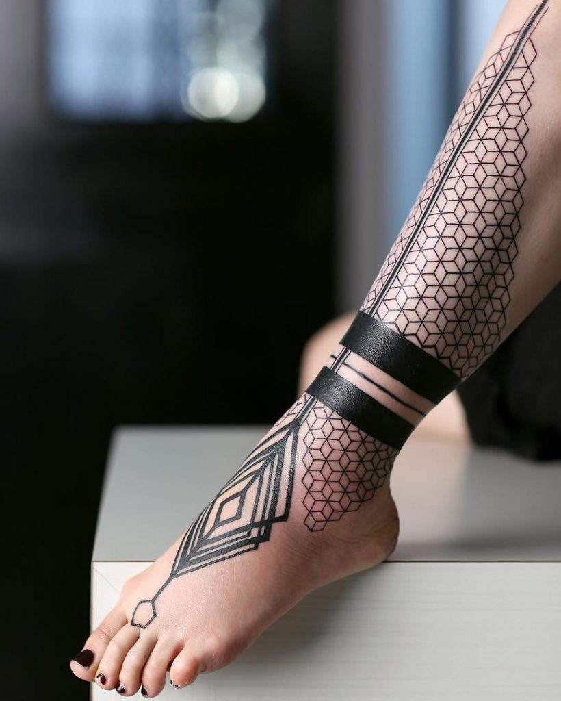 Black geometric pattern tattoo on the leg