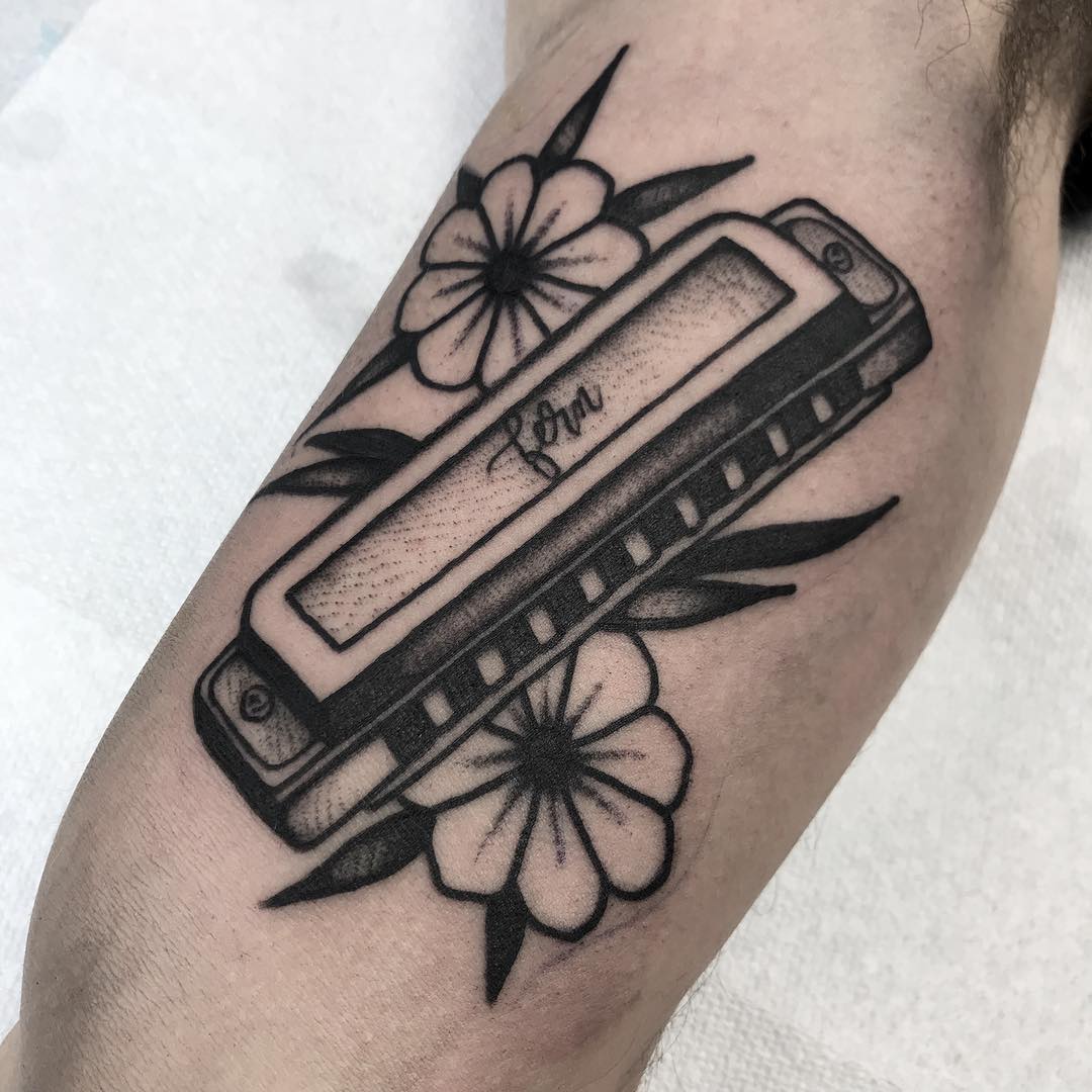 Black harmonica tattoo
