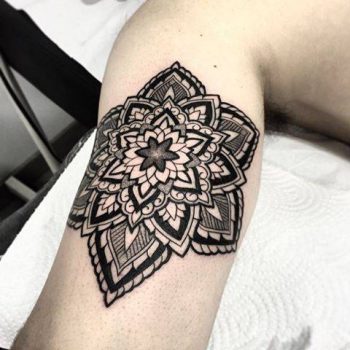 Black mandala on the right bicep