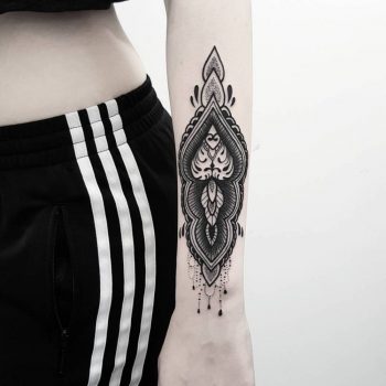Black ornament tattoo on the left wrist