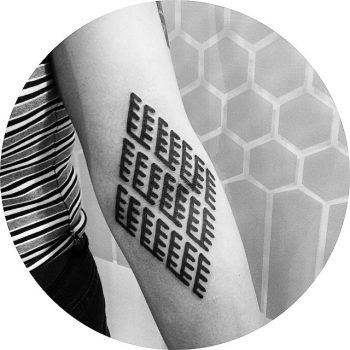 Black rhombus shaped ornament tattoo