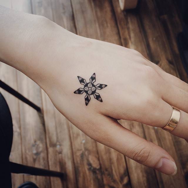 Black snowflake tattoo
