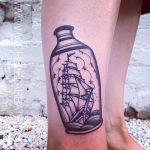 Black tattoo of a ship in a vase