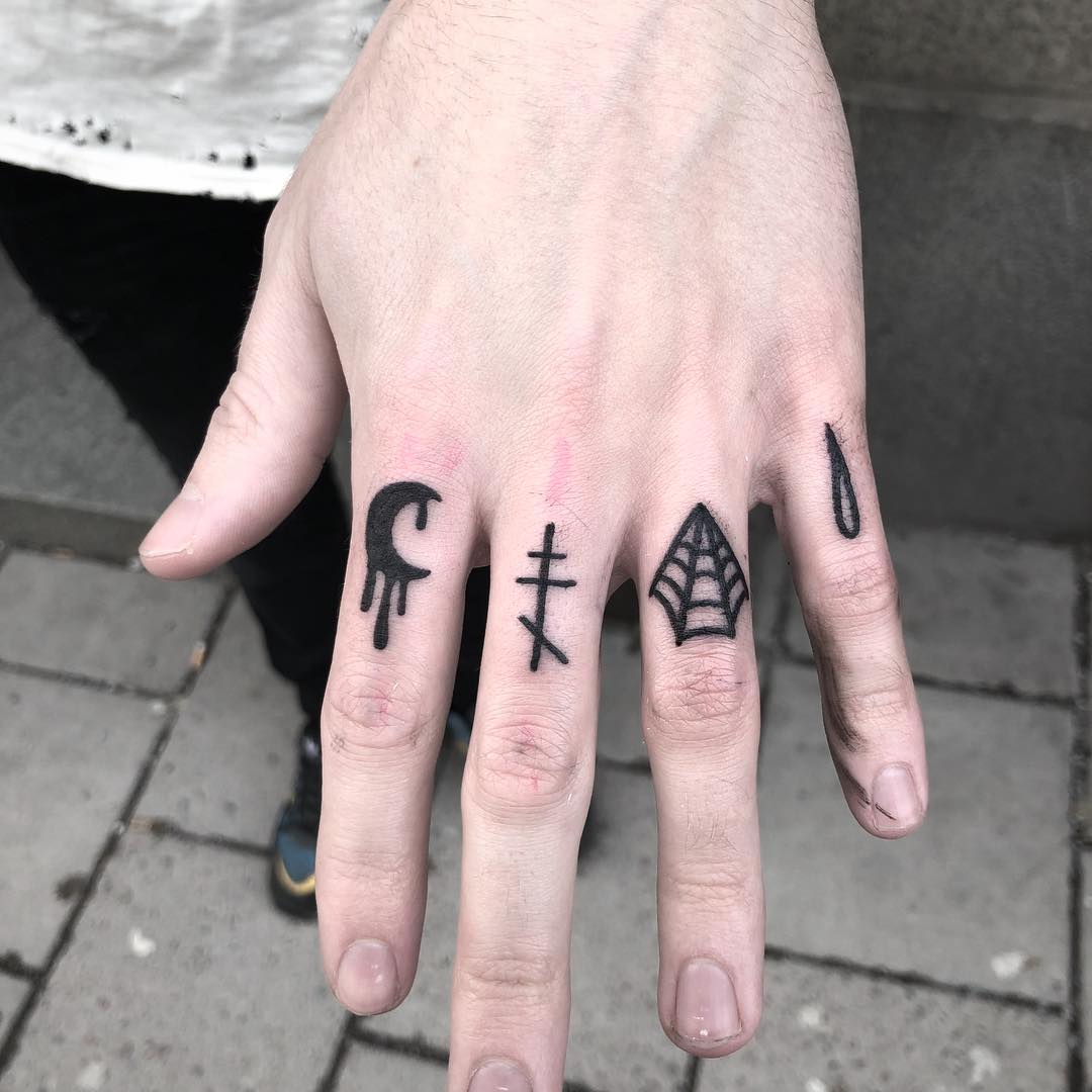 Black tattoos on fingers