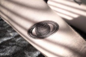 Blackwork style saturn tattoo