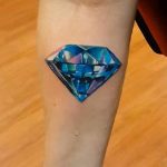 Blue diamond tattoo on the forearm
