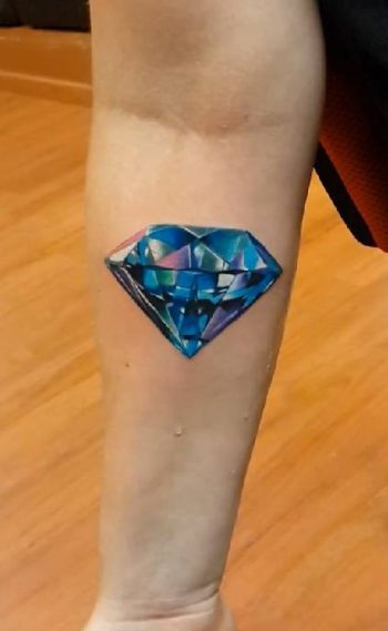 Blue diamond tattoo on the forearm
