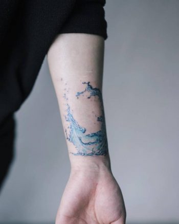 Blue wave tattoo on the wrist