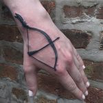 Bow and arrow tattoo on the hand