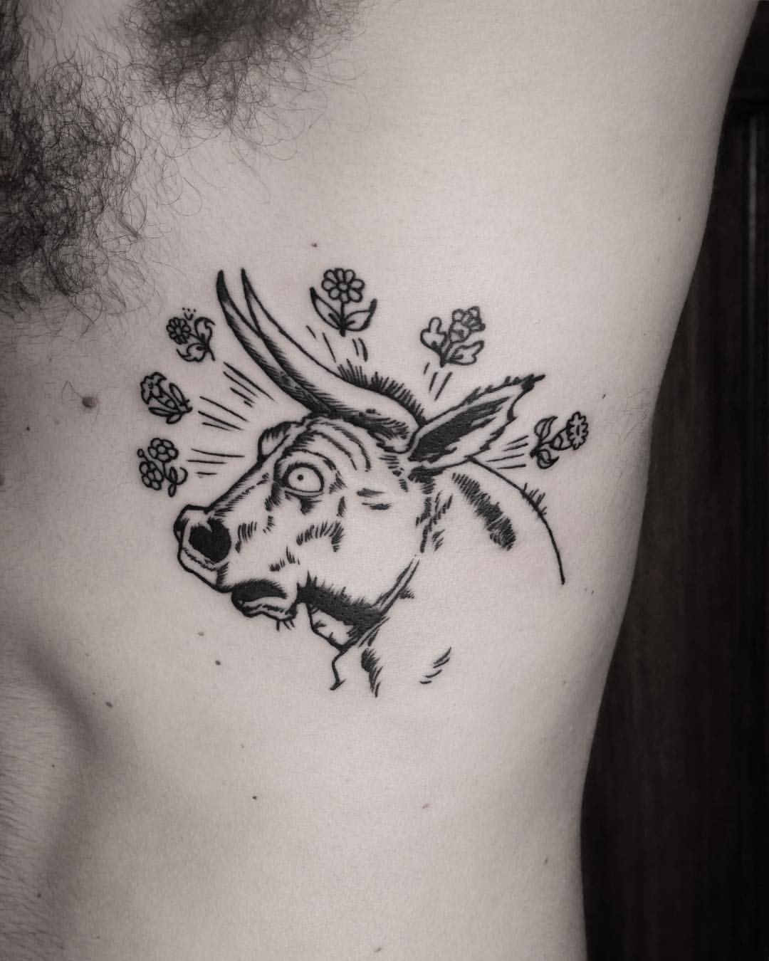 Bull tattoo on the rib cage