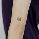 Burger tattoo on the arm