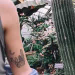 Cacti and crescent moon tattoo on the arm