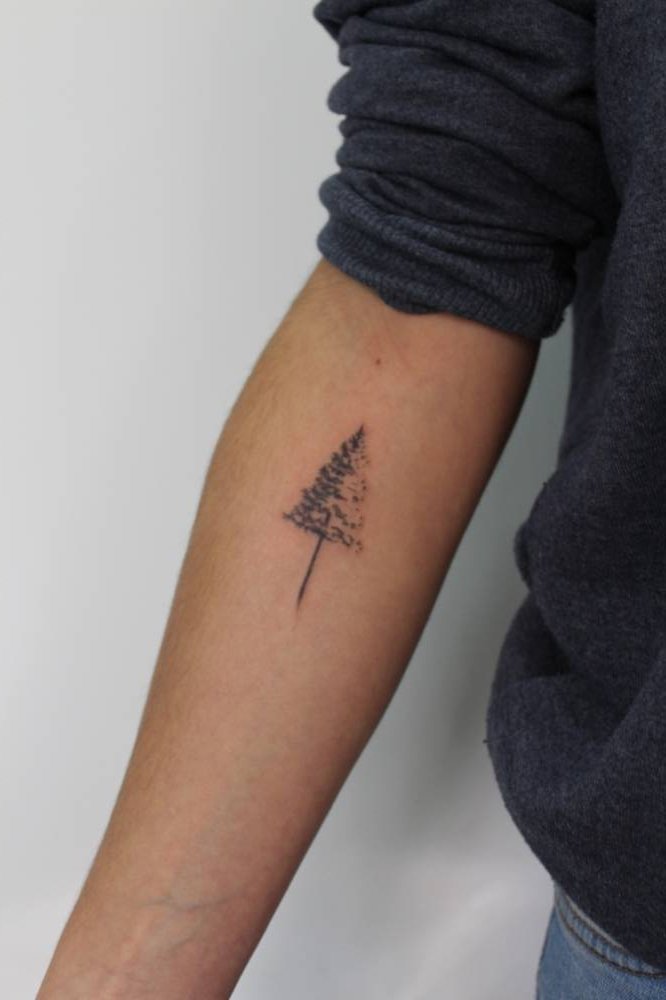 Christmas tree tattoo on the forearm