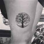 Circular black tree tattoo