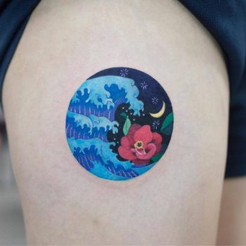 Circular colorful wave tattoo on the thigh