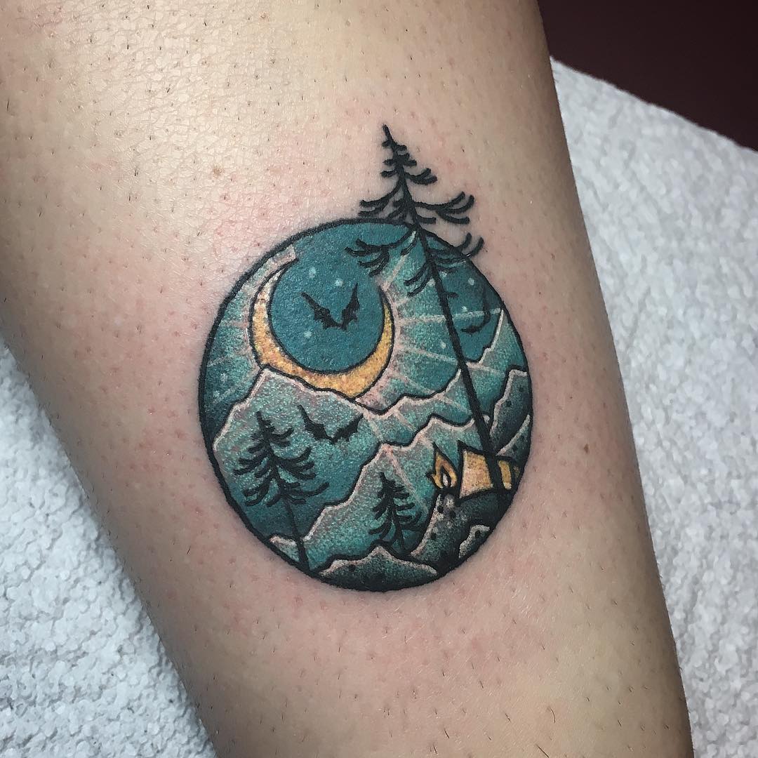 Circular mountain and forest landscape tattoo