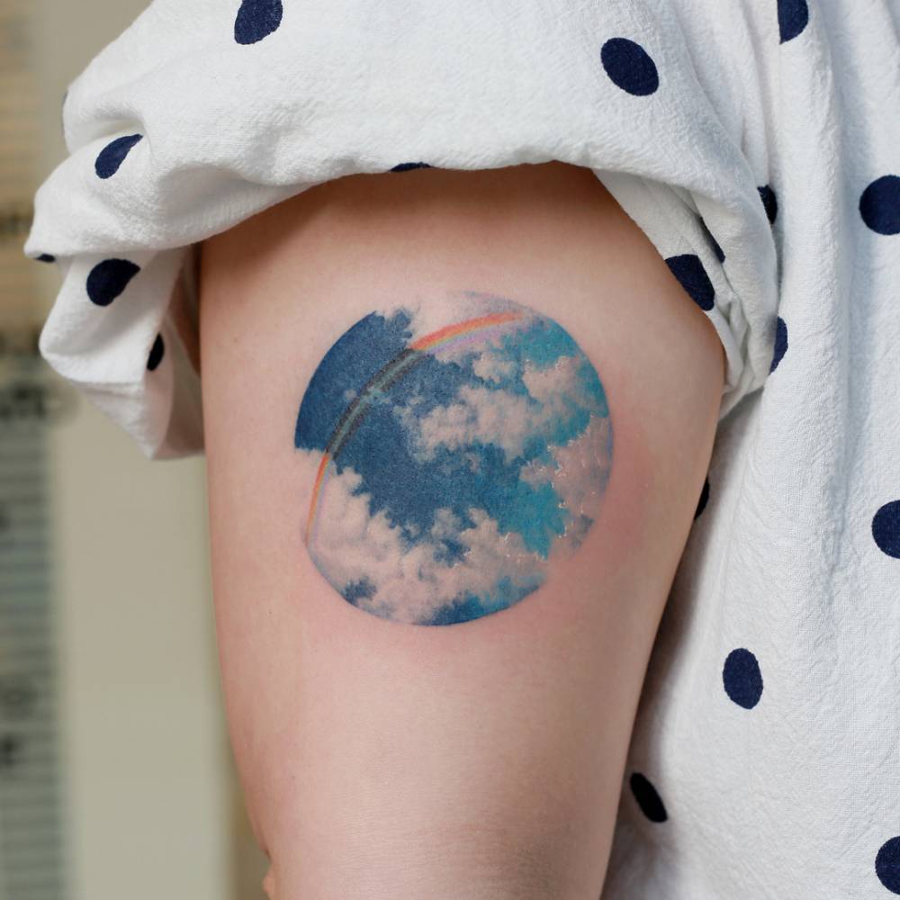 Circular sky tattoo