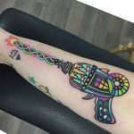 Colorful dna laser gun tattoo