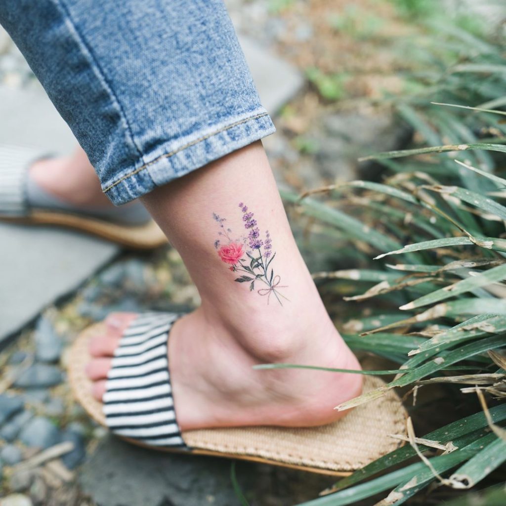 Colorful flowers tattoo on the left ankle